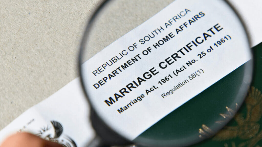Marriage certificate checking closely with passport